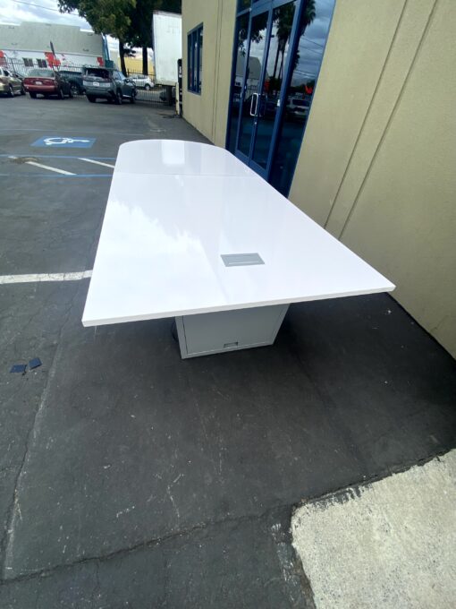 white bullet shaped conference table