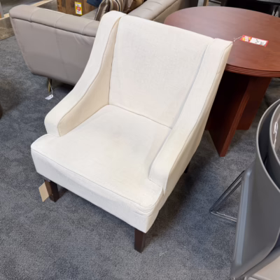 cream colored club chair with wooden legs